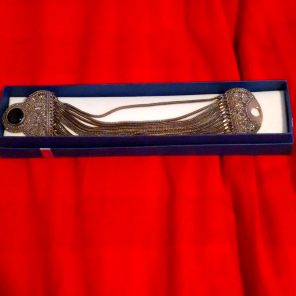 A Silver bracelet with a blk Onyx.